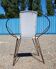 Black metal reclining armchair with white plastic caning.