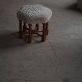 Pair of mid-century Danish oak stools with shearling lambswool upholstery, 1950s.