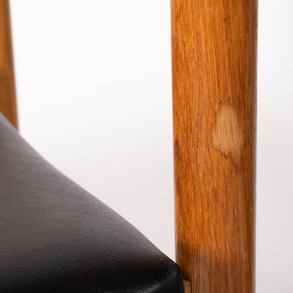 Oak chair with a black leather seat made in the 1960s