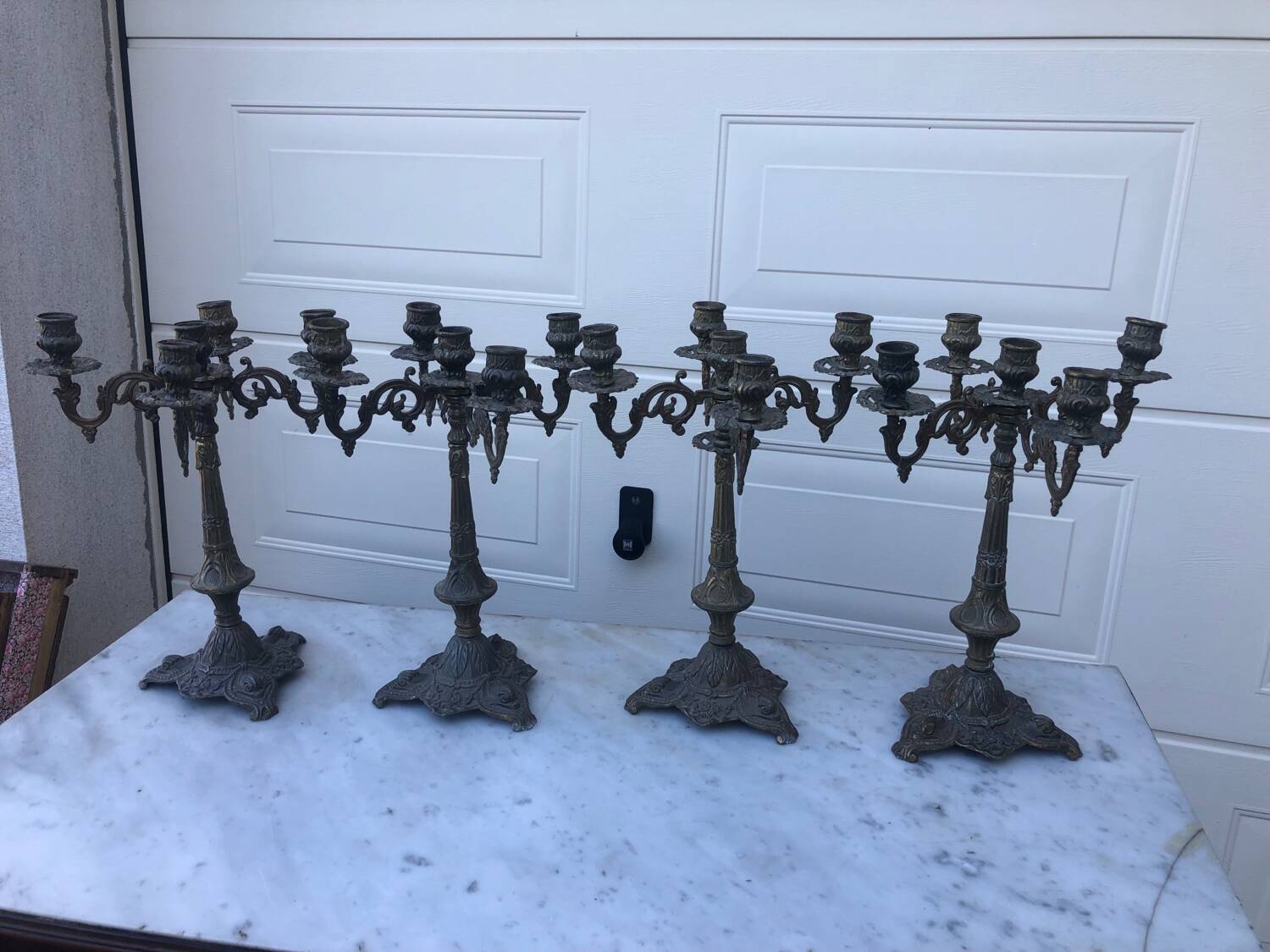 4 identical old brass candlesticks