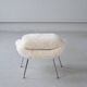 Womb Chair and Ottoman in fluffy white fabric by Eero Saarinen