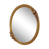 Oval mirror with a gilded frame and carved with bouquets of roses