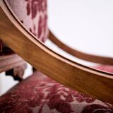 Antique lacquered wooden armchair with burgundy fabric, carved, before 1890.