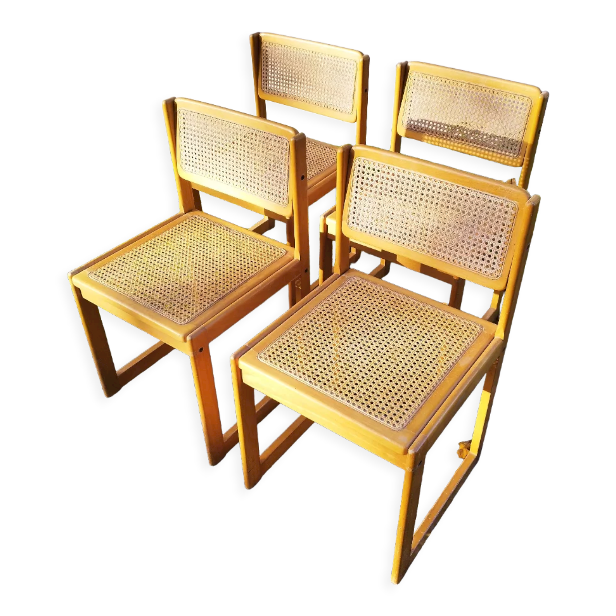 Four trendy tanned wooden chairs