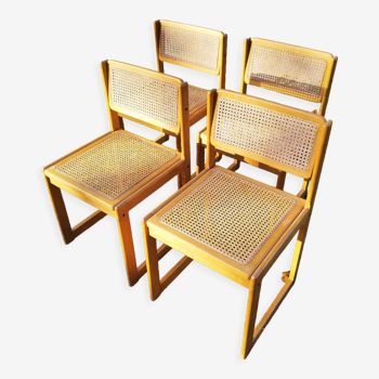 Four trendy tanned wooden chairs