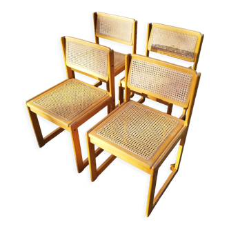 Four trendy tanned wooden chairs