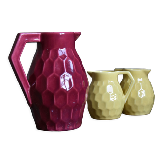 Raspberry carafe and two yellow pitchers