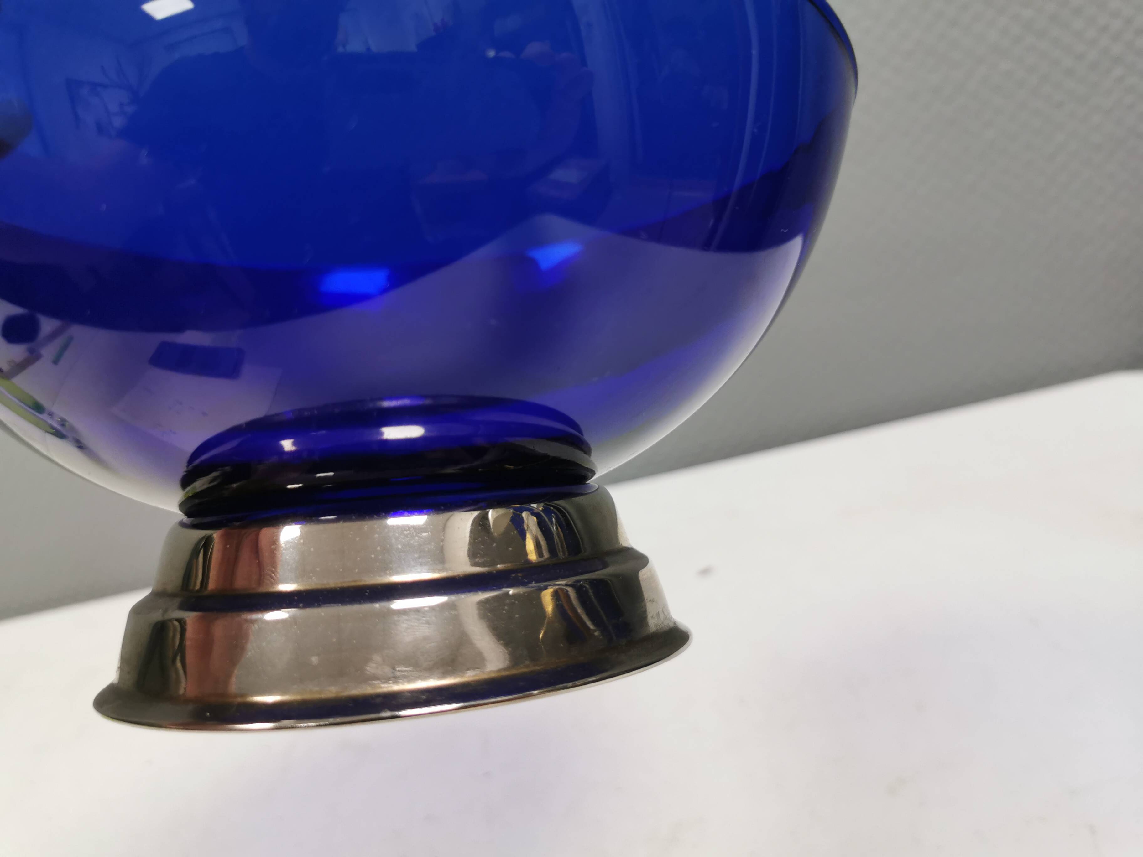 Beautiful blue glass bowl mounted on silver colored base (Original).