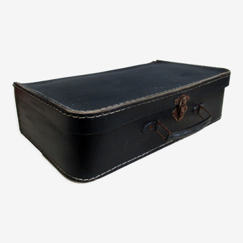 Small suitcase in old navy blue cardboard