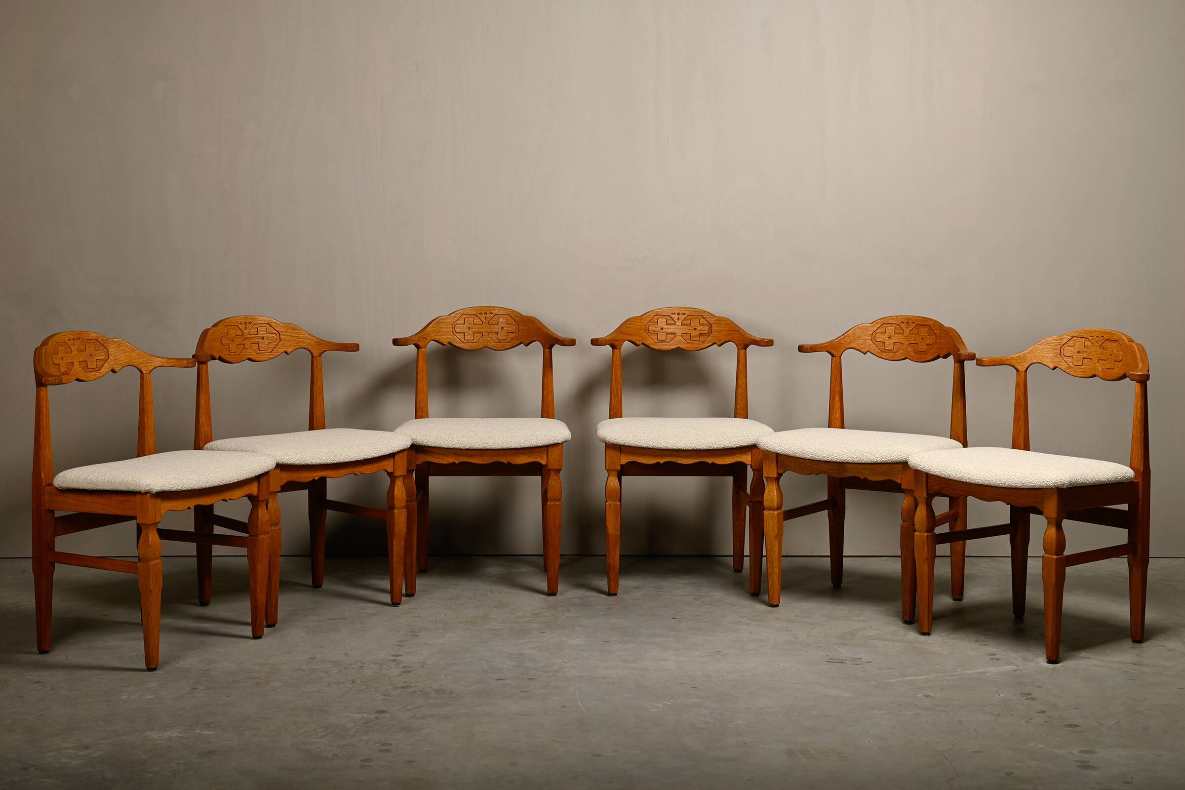 Henning Kjærnulf dining chairs set in Oak and Off White Bouclé, Denmark, 1960s