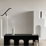 Black solid monoxyl wood bench carved into 3 arches