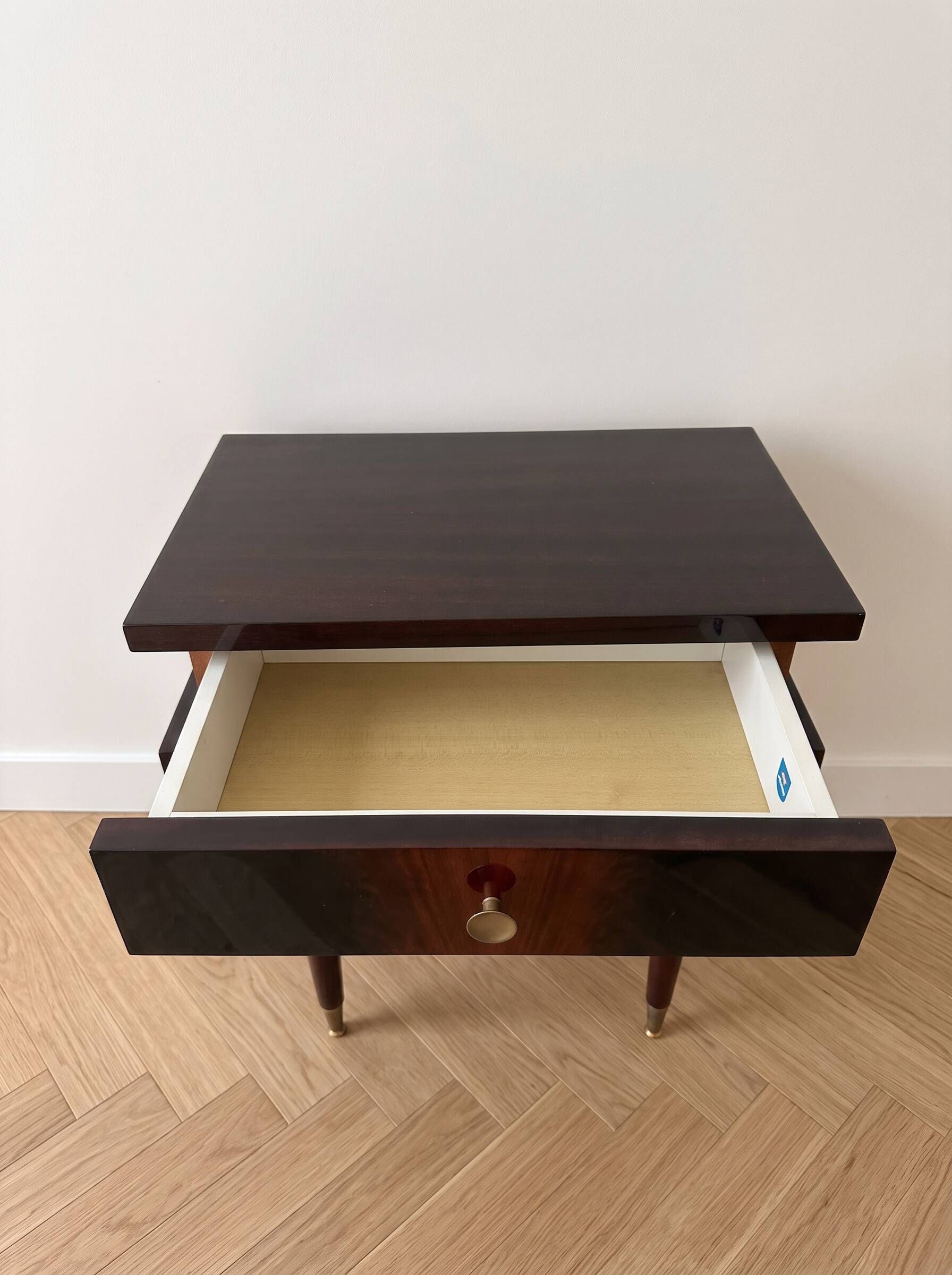 Vintage Art Deco bedside table in dark wood with gold details.
