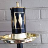 Vintage floor ashtray with a gold and black metal cigarette dispenser.