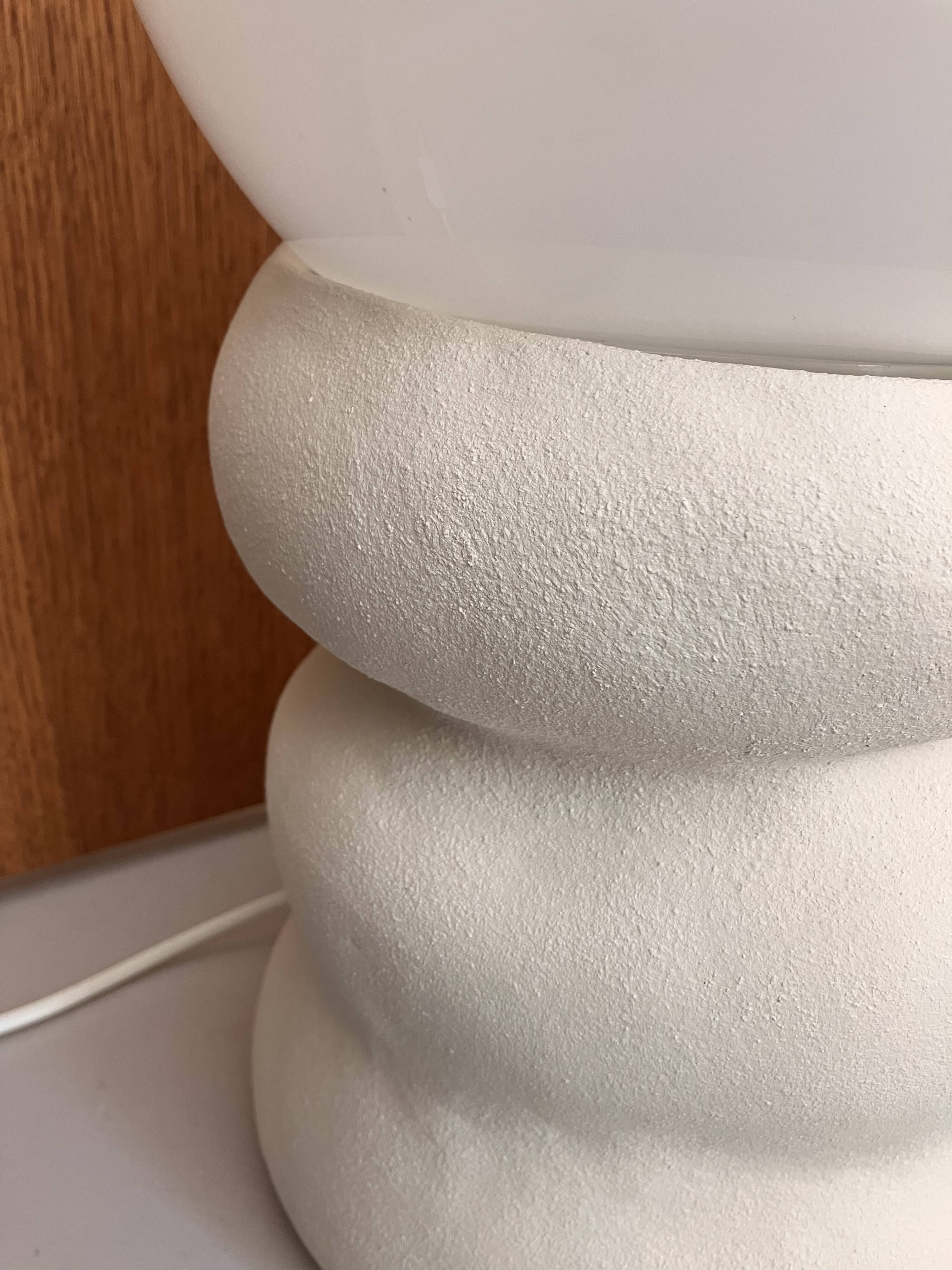 Large table lamp in off-white ceramic with an organic globe shape.