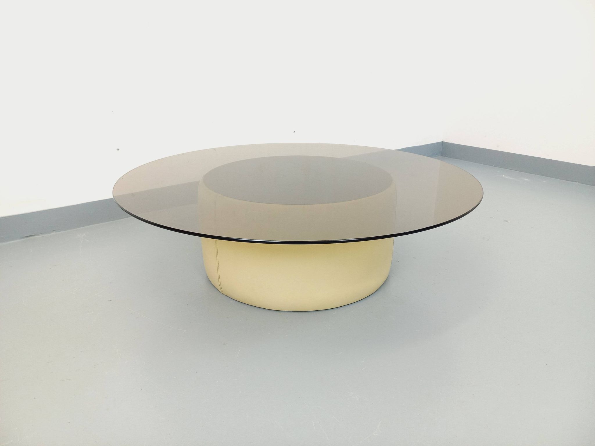 Vintage round coffee table in glass, leather, and metal in Space Age style from the 70s.