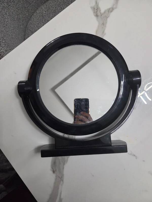 Vintage round pivoting mirror in black, retro style from the 70s/80s.