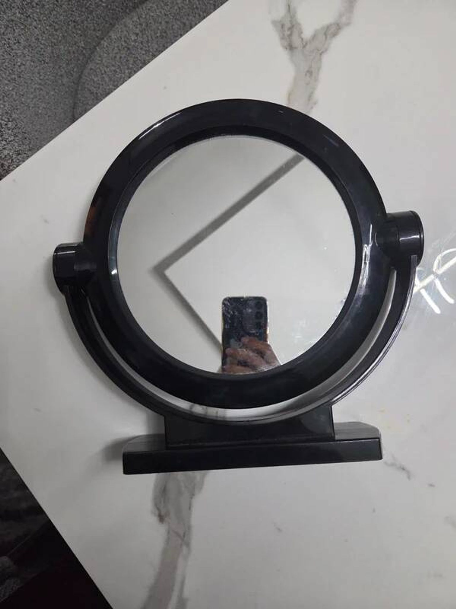 Vintage round pivoting mirror in black, retro style from the 70s/80s.