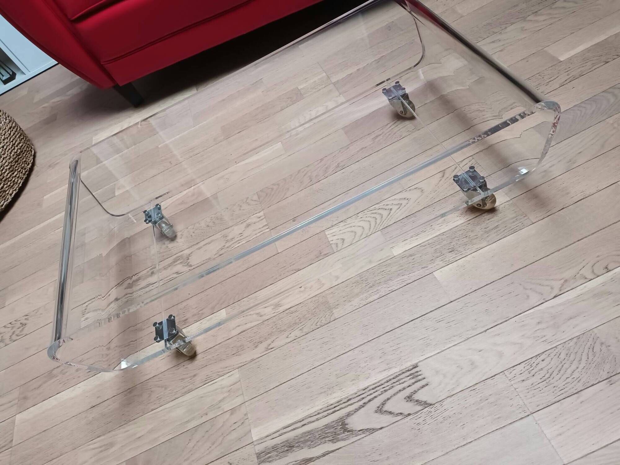 Design coffee table from Habitat in transparent plexiglass, mounted on wheels.