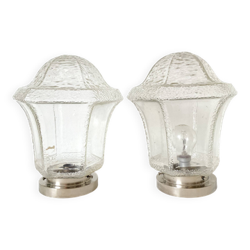 Pair of lantern-style ceiling lights or antique lamps.