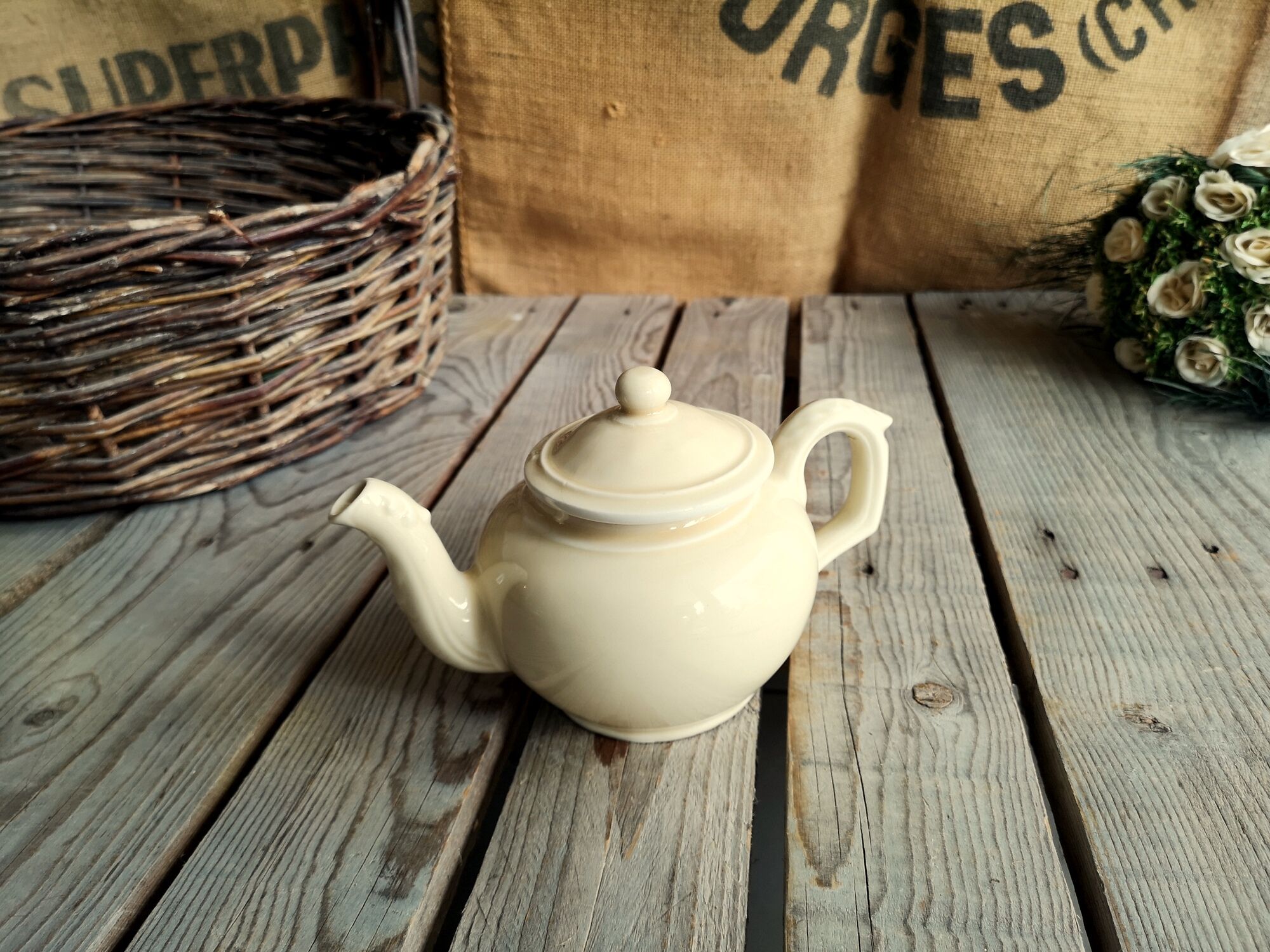 Little ancient teapot in ceramics color cream