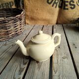 Little ancient teapot in ceramics color cream
