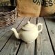 Little ancient teapot in ceramics color cream
