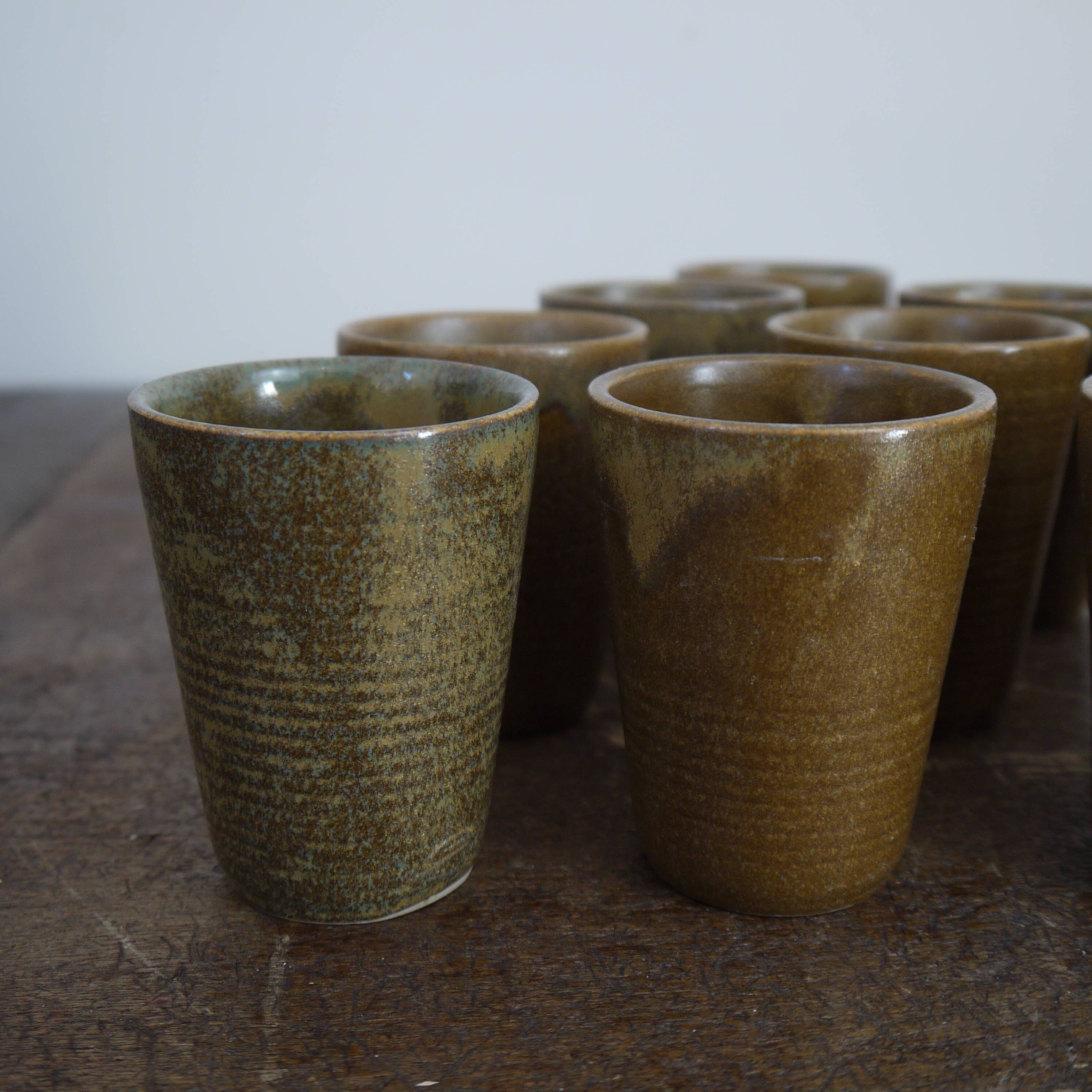 Lot of ten cups of Digoin sandstone