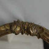 Oval mirror in gilded wood