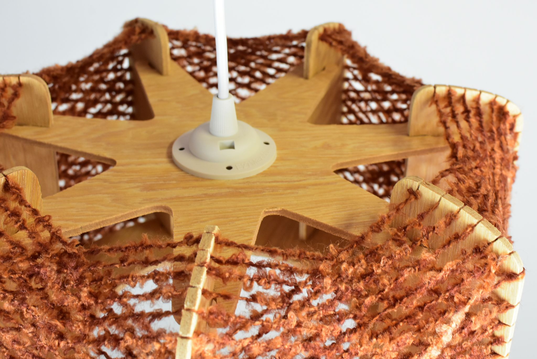 Brown wire and wood pendant light.
