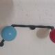 Vintage wall coat rack "Atomic" in wrought iron with multicoloured balls.
