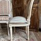 Pair of Louis XVI style chairs in painted wood and satin, classic elegance.