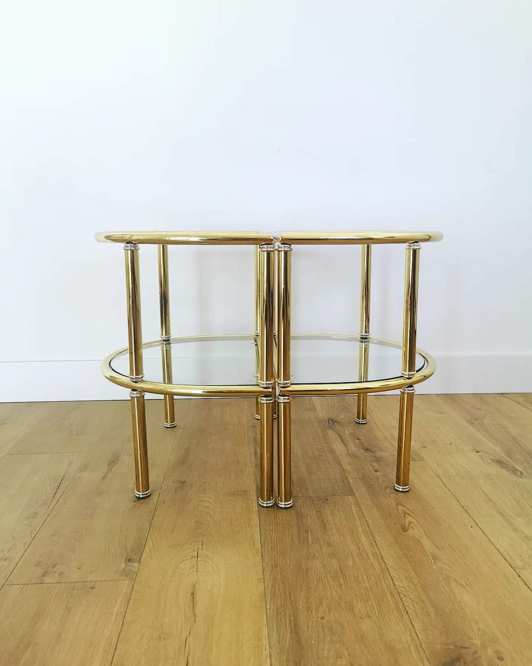 Pairs of gilded metal bedside tables and glass tops