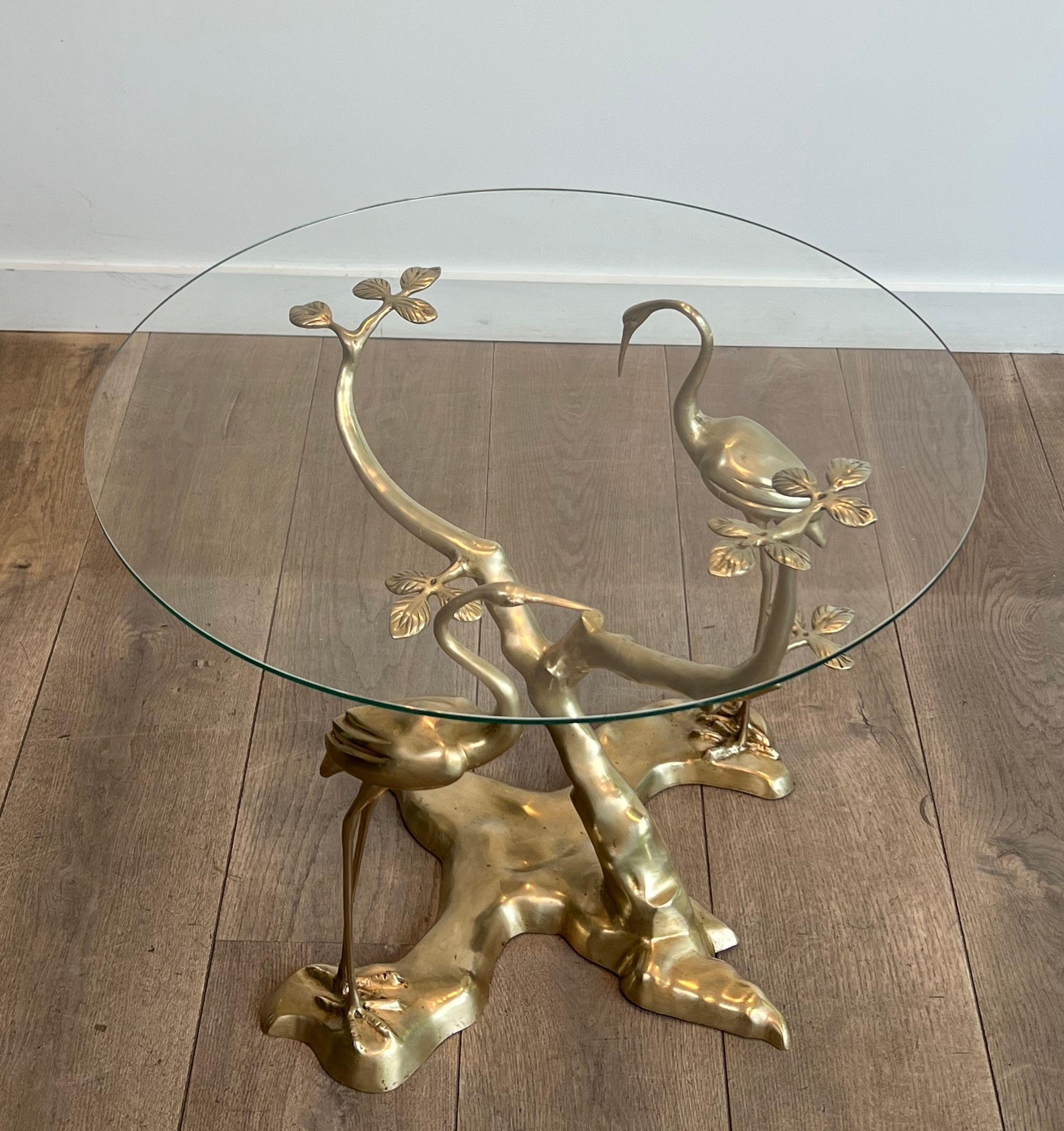 Coffee table model with cranes surrounding a brass bonsai and round glass top by Willy Daro.