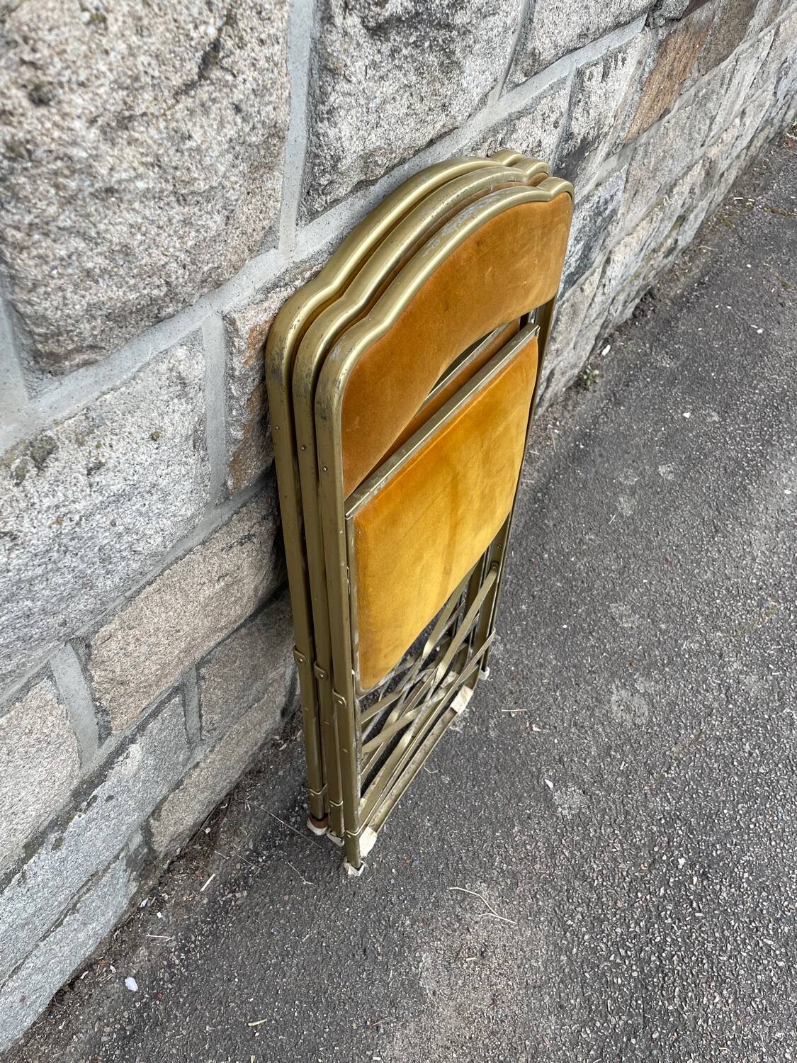 Three folding opera chairs in old gold velvet and brass structure