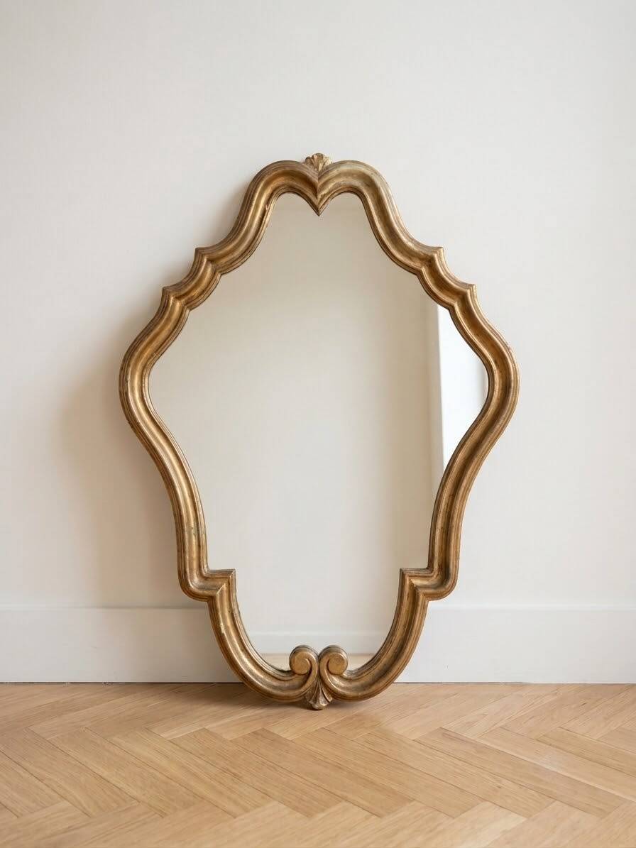 Antique mirror with a gilded wooden frame.