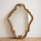 Antique mirror with a gilded wooden frame.