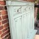 Cloakroom with sage green wall coats