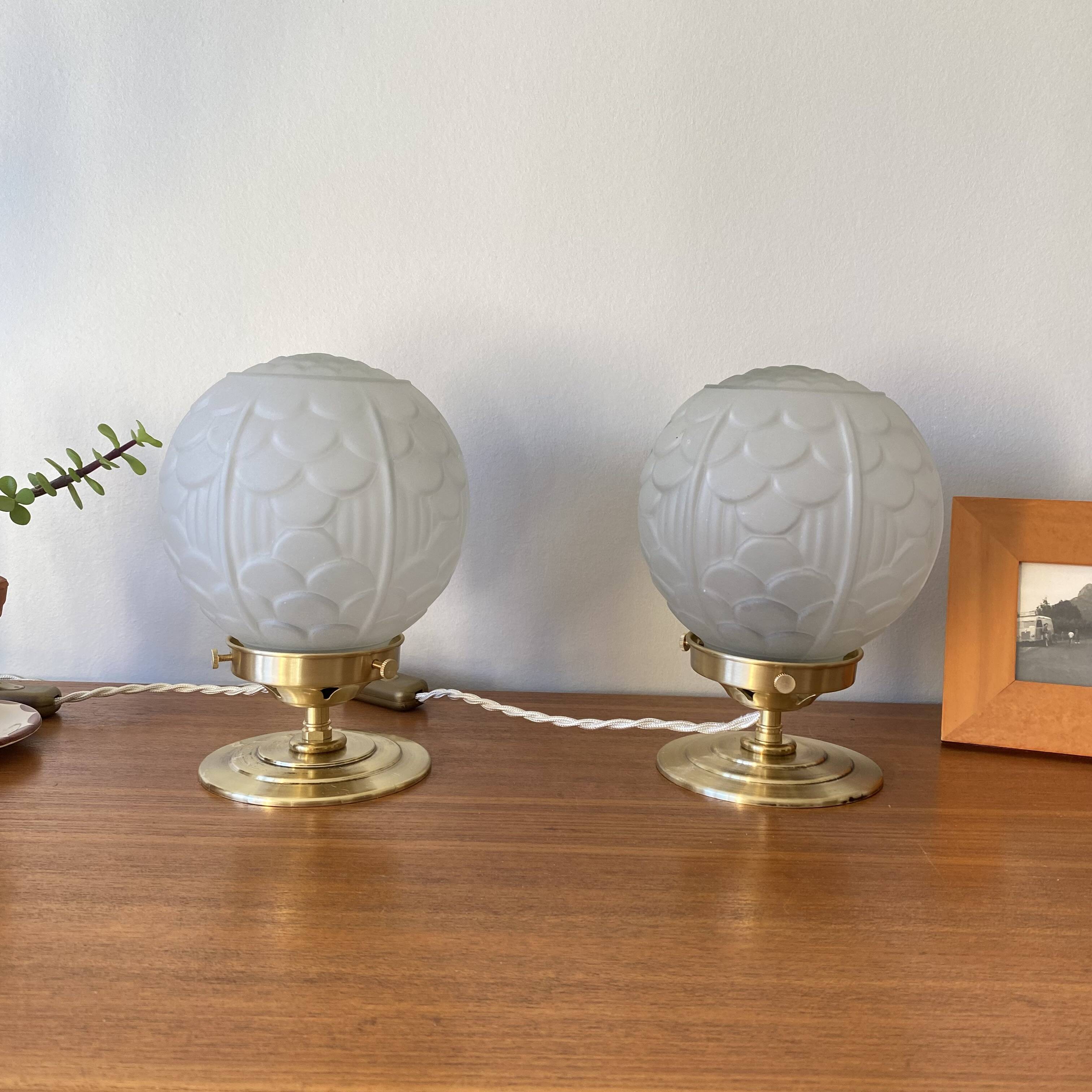 Pair of Art Deco glass globe table lamps with brass base.