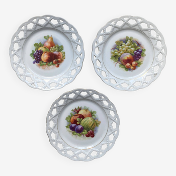 Old openwork earthenware plates decorated with fruit and vintage gilding