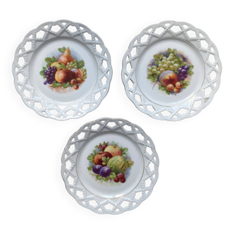 Old openwork earthenware plates decorated with fruit and vintage gilding
