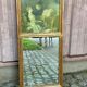 19th-century trumeau with mirror and music lesson canvas.