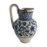 Oriental pitcher in white background and blue floral decoration