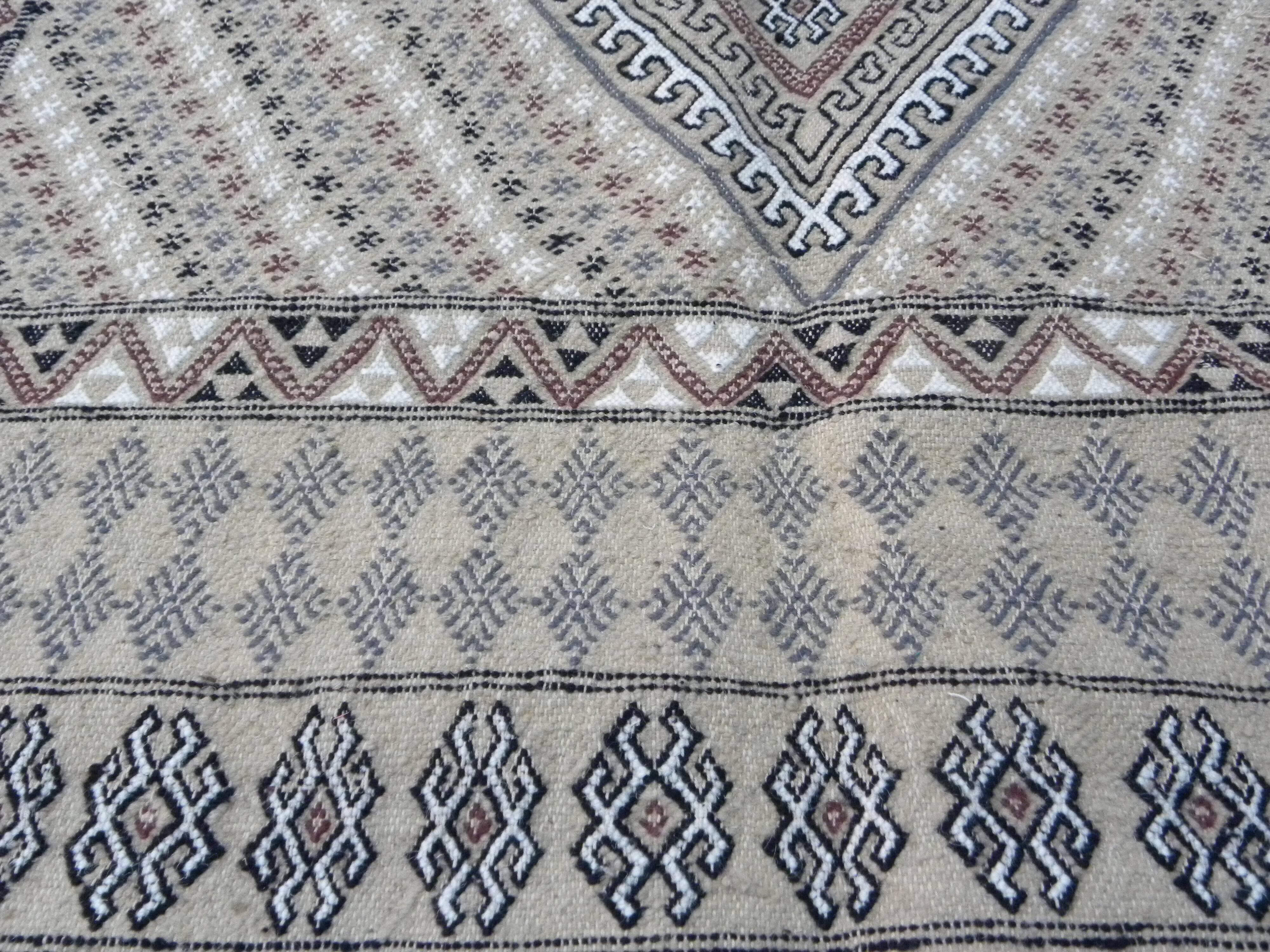 Traditional handmade Berber carpet in brown and beige wool.