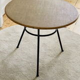 Tripod coffee table with a straw covering.