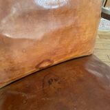 Vintage leather club chair with wooden armrests