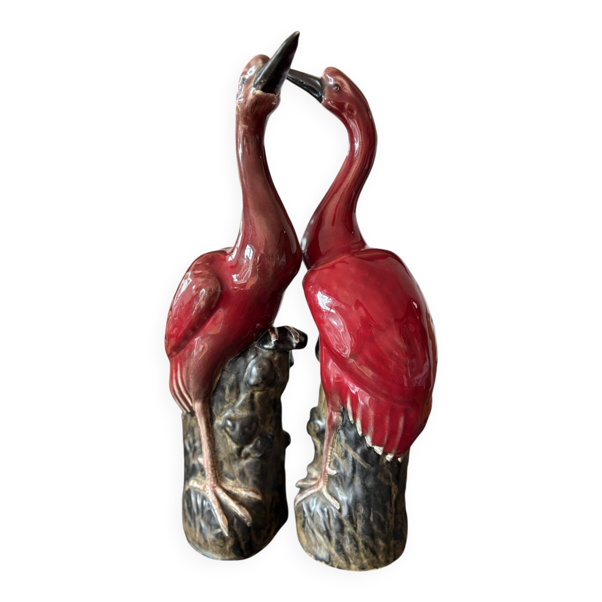 Pair of ceramic red glazed wading bird (crane) figurines.