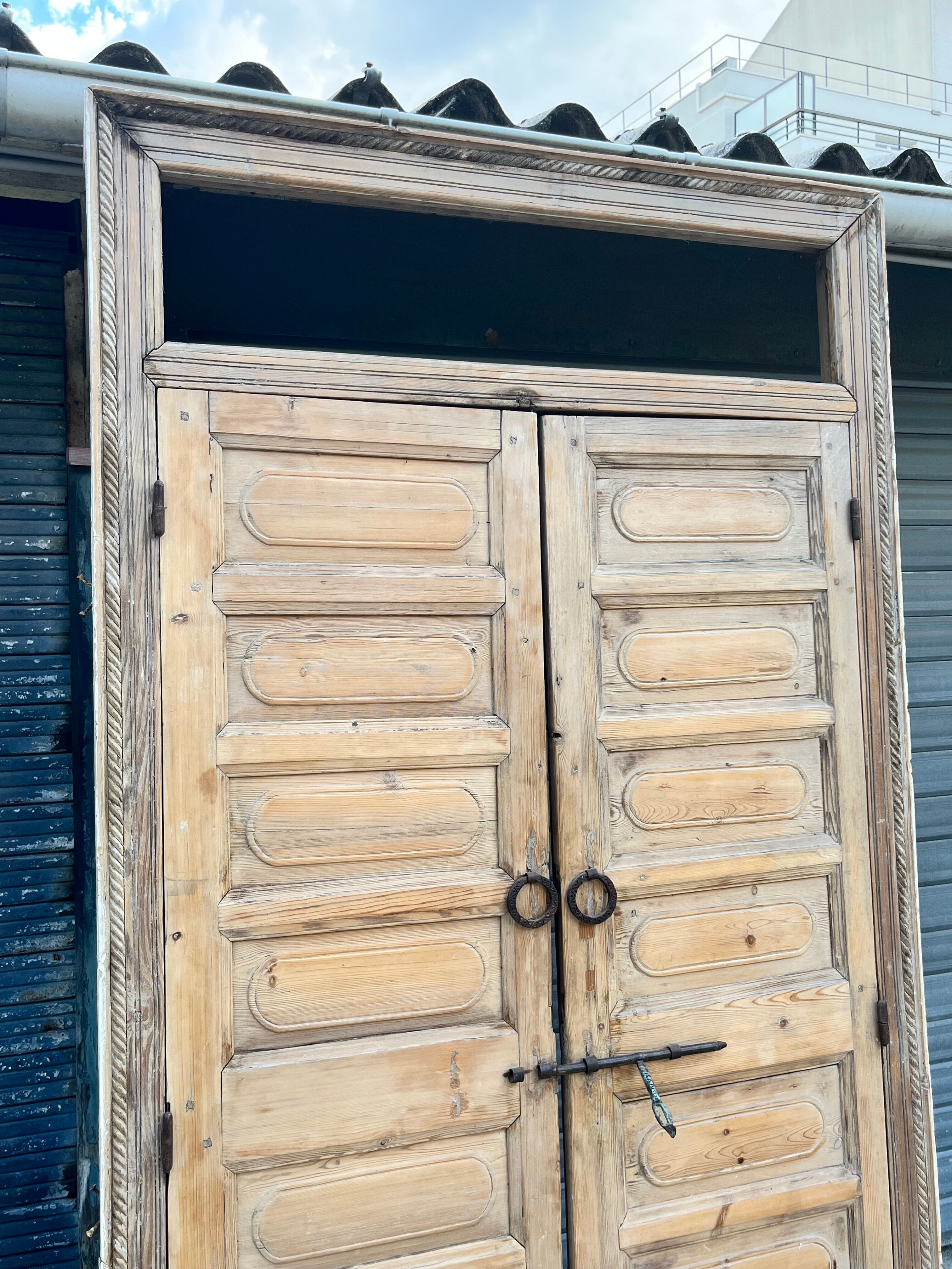 pair of old double-leaf doors with transom and carved frames