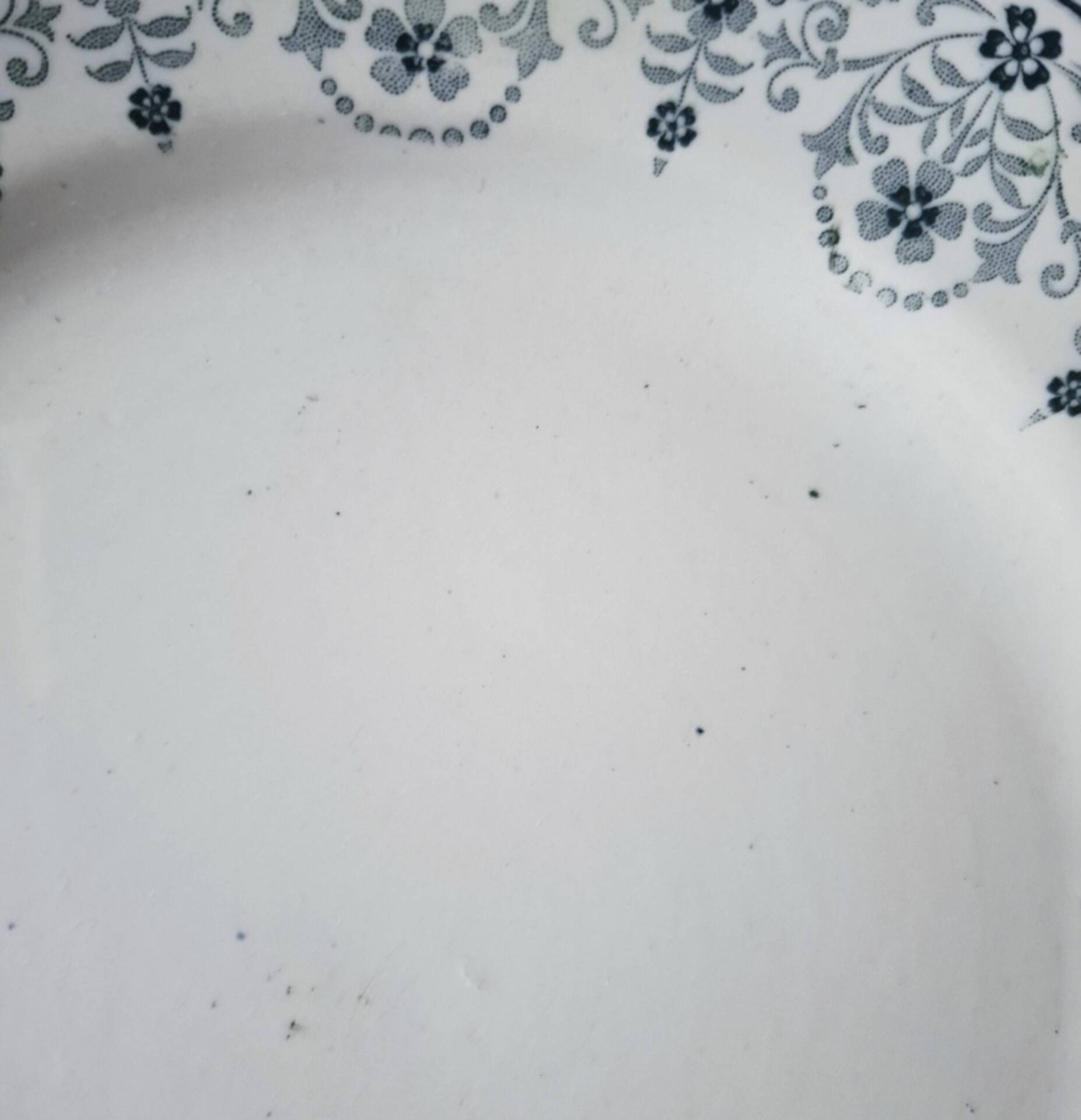 Old mismatched flat plates made of ironstone earthenware.