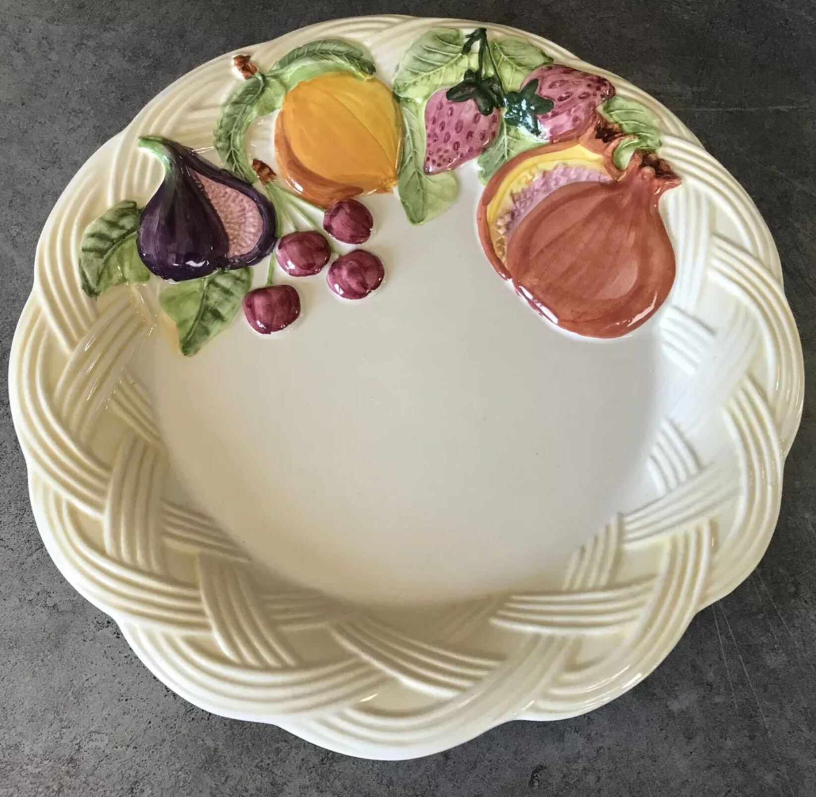 Vintage plate in ceramic enamelled decoration of fruits in relief