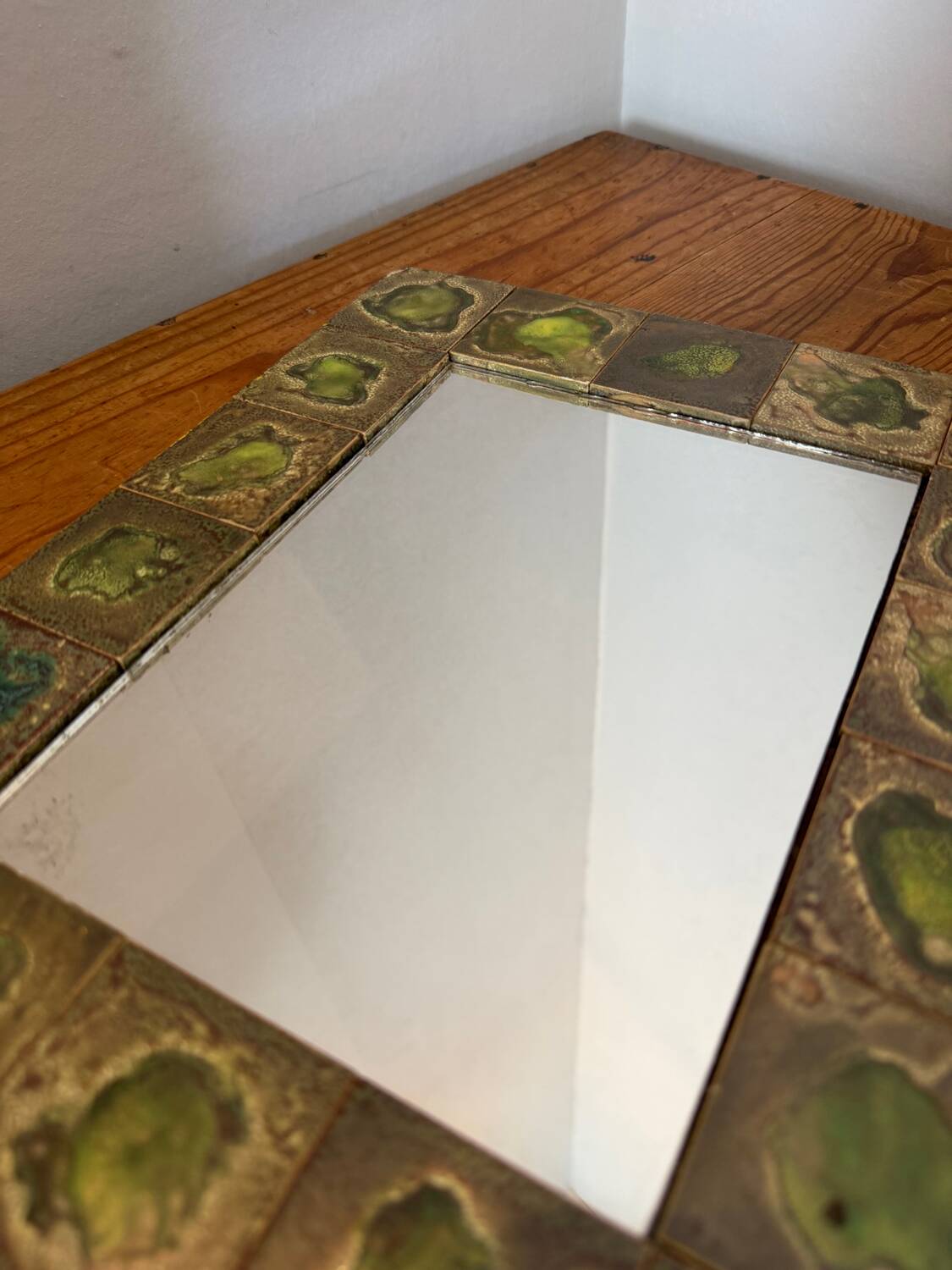 Vintage 1960s green and brown glazed ceramic mirror.